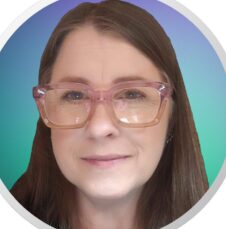 Commencement_Thai_Ray_Williams Headshot of woman wearing pink glasses, smiling slightly against a blue and green gradient background.