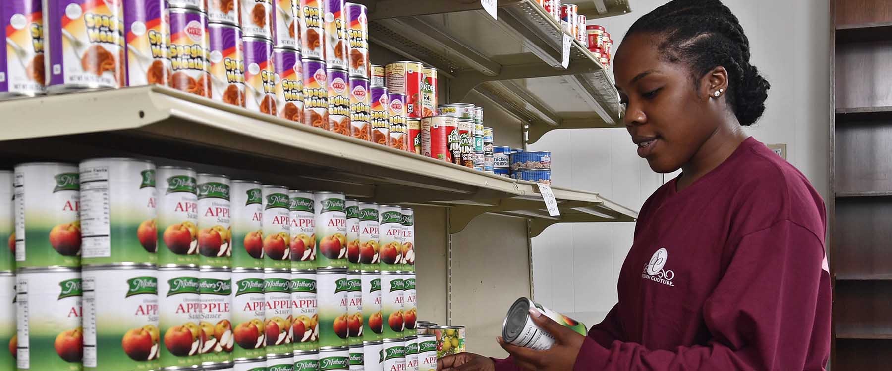 Photo: Student volunteers like Vivian Ojimadu help stock and operate the Jamil Niner Food Pantry.