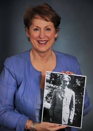 Jeanette Sims holds a photo of her late father, J. Bryan Sims Jr.