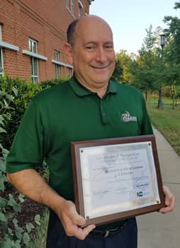 Schallert with the University's Certificate of Recognition