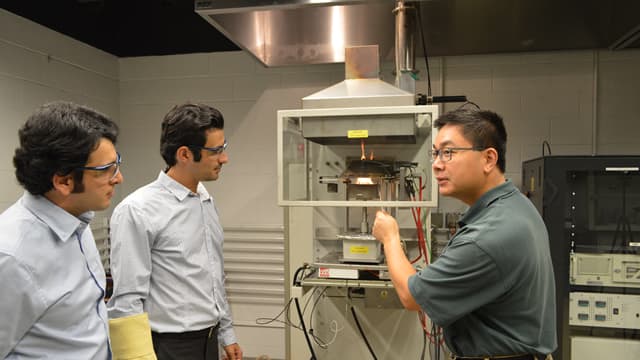 Aixi Zhou (right) conducting lab tests for fire ember study