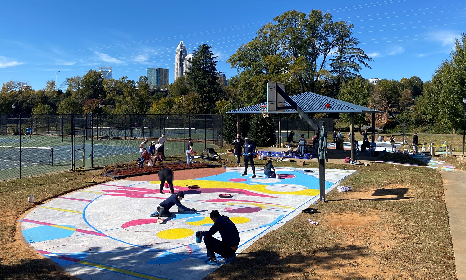 COA+A students painting the basketball courts at Alexander Street Park