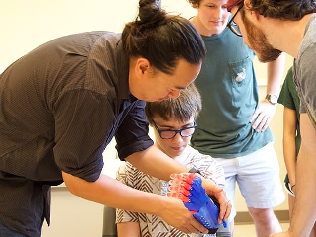 Dr. Richard Chi fitting a prosthetic