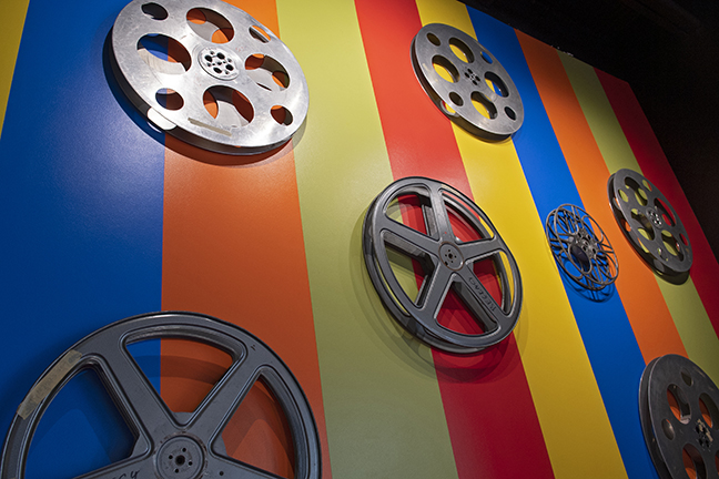 Colorful wall art with empty movie reels hanging