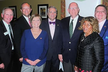 Front row, l to r: Rep. Mary Belk (06)' and Sen. Joyce Waddell (73) 'Back row, l to r: Chancellor Phil Dubois, Rep. Dean Arp ('99), Rep. Kelly Hastings ('09), Rep. Bill Brawley ('78) and Rep. Jason Saine ('95)