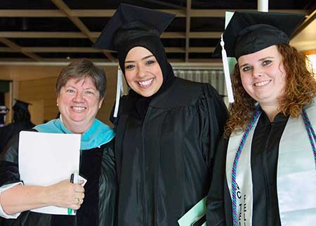 Kim Harris with students at a past commencement