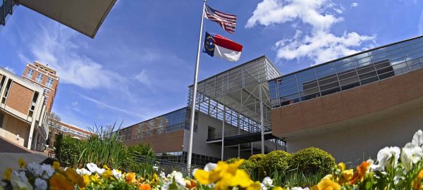 The NC and US flag fly outside Reese on campus.