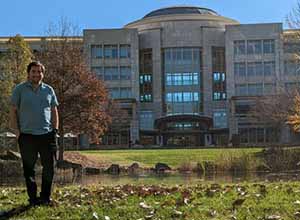 Richard Stern poses outside campus building