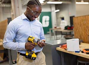 Jabrail McBride works with a power drill