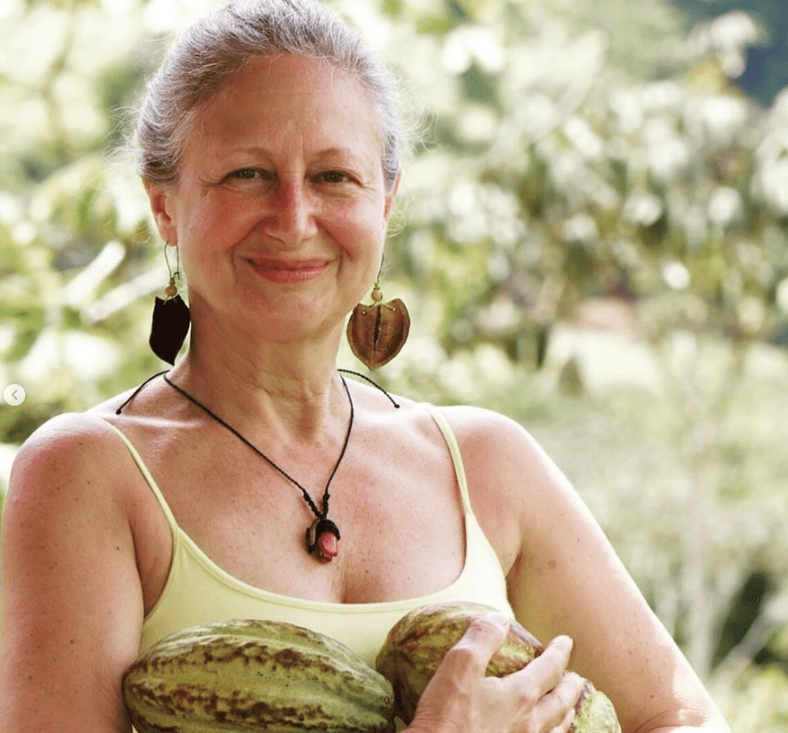 Esa with chocolate woman holding cocoa beans