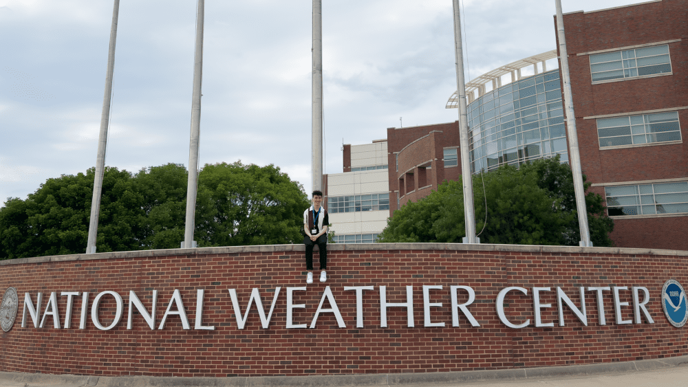 Ian Shank sitting outside the National Weather Center in Norman, Oklahoma