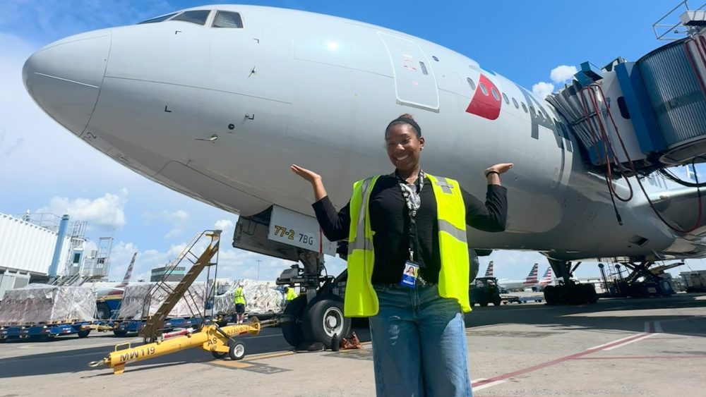 Myla Marve on the CLT tarmac posing by an airplane
