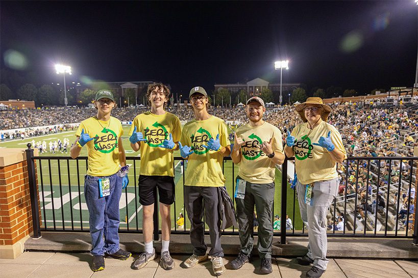 A group of zero-waste stewards and staff members at a home football game