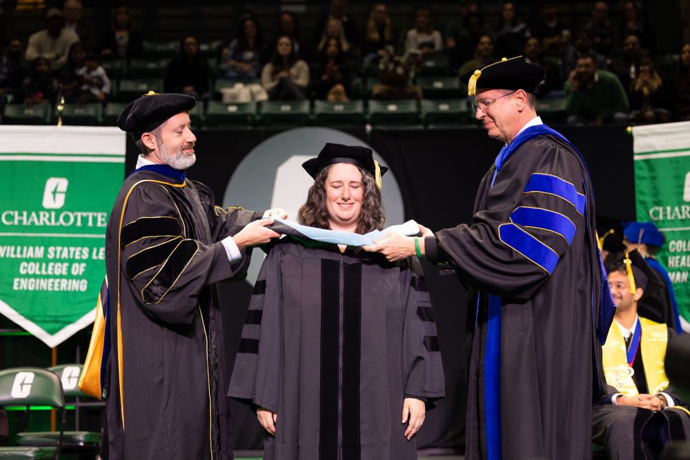 A student is hooded during the Graduate School ceremony