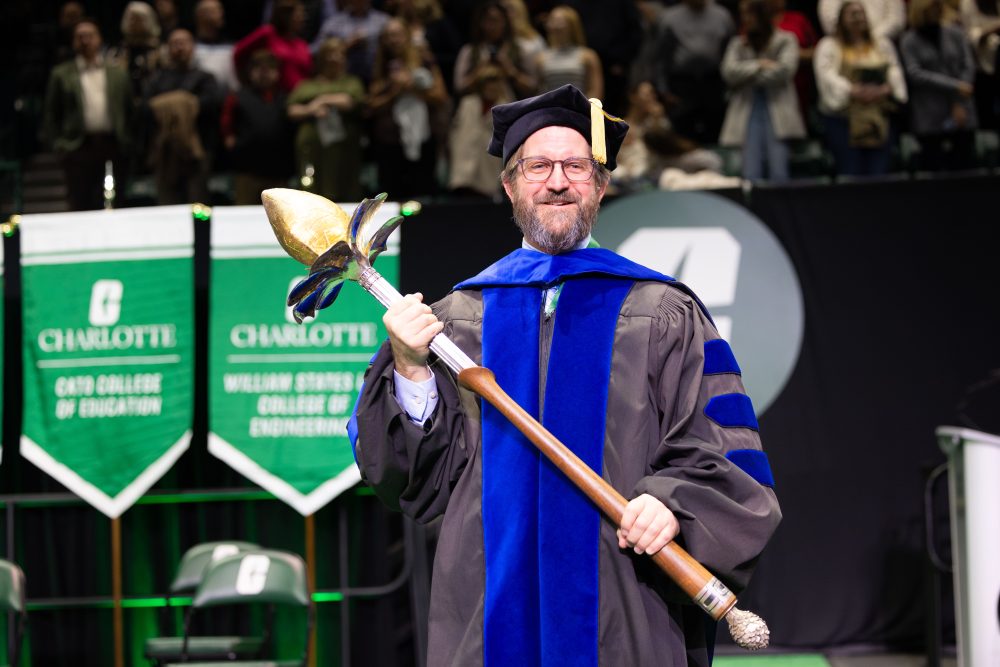 University Marshal wields University mace at fall 2025 commencement
