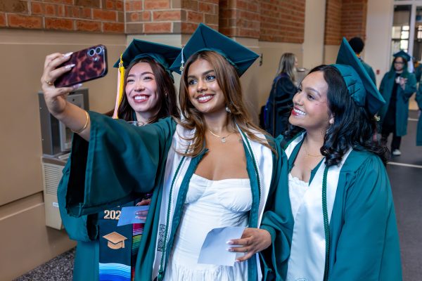 Smiling graduates take a selfie
