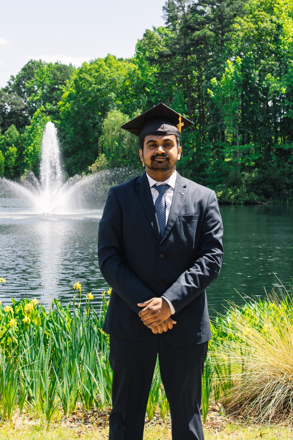 Bell Ringer Shailesh Kumar wears graduation cap by Hech Lake