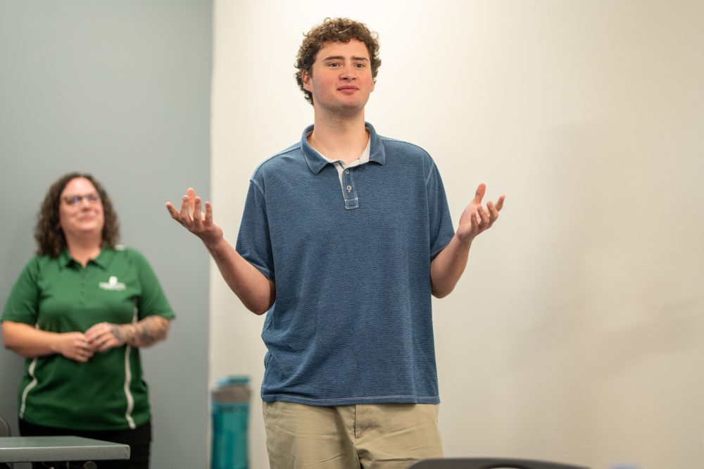 Cayman Powell explains his project at the Student AI Fellows showcase