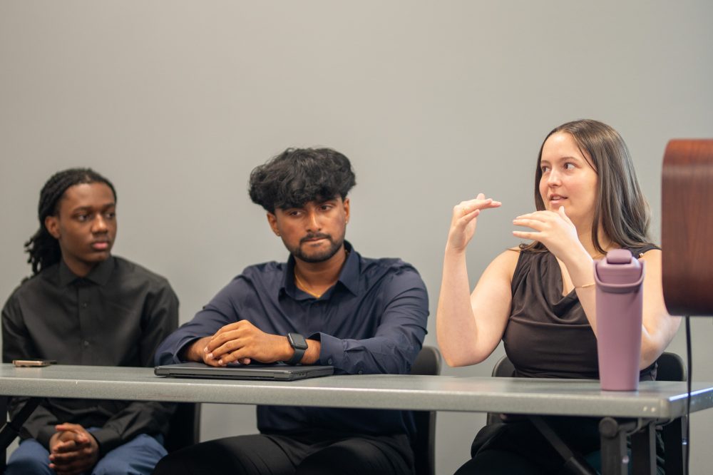 Rachel Bland answers question at the Student AI Fellows Showcase