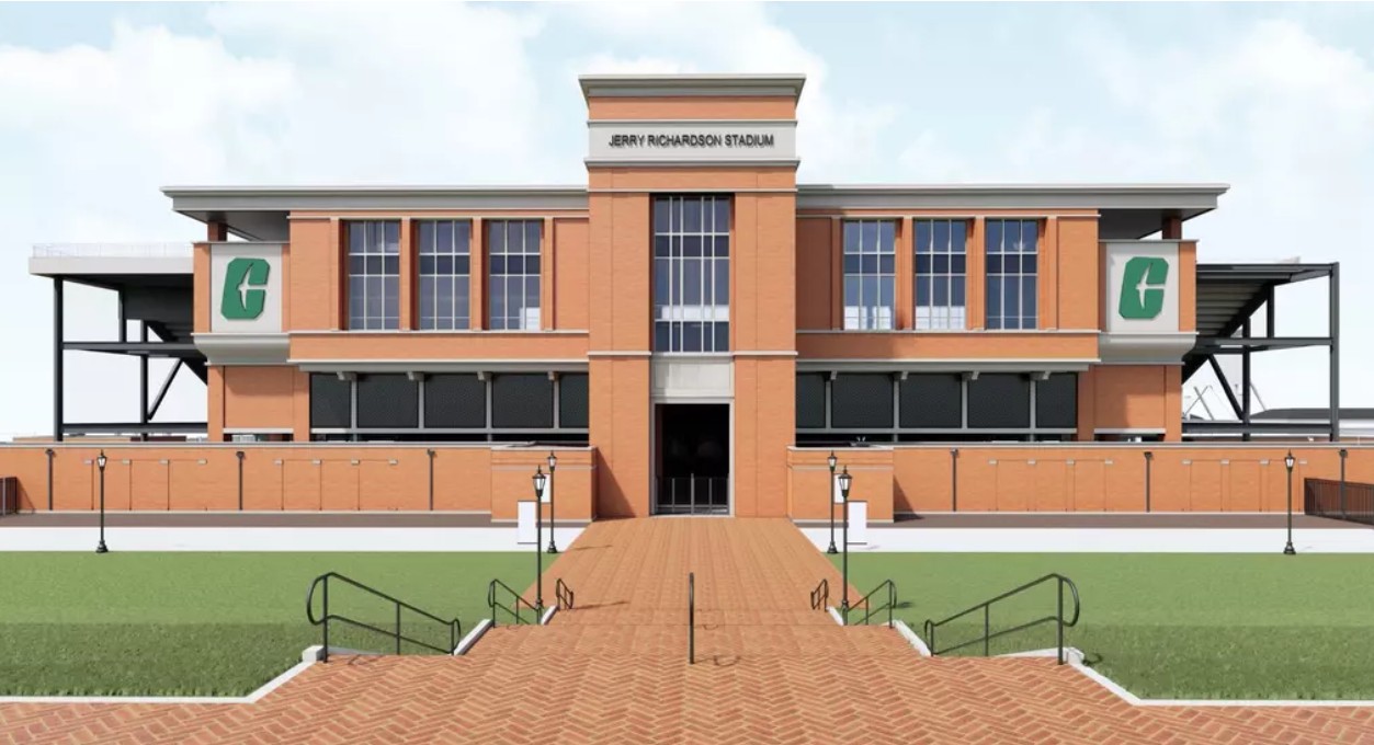Rendering 6 Architectural rendering of the completed west-side entrance to Jerry Richardson Stadium, highlighting the expanded premium seating structure with a brick façade, central entrance, and University of North Carolina at Charlotte branding.
