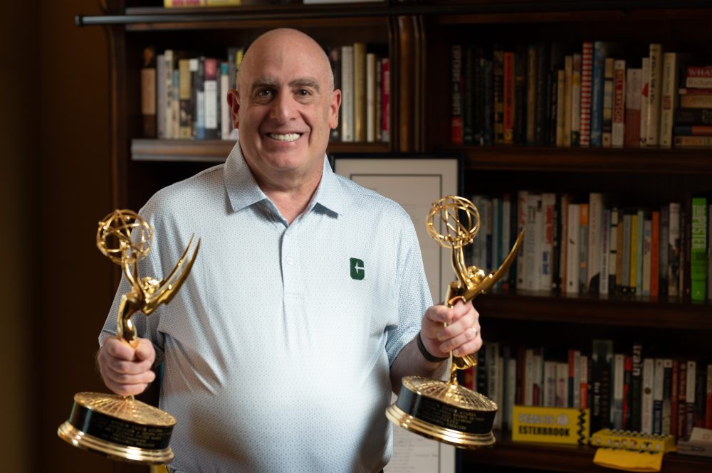 Joe Posnanski holds his two Emmy awards at his home in Charlotte, North Carolina