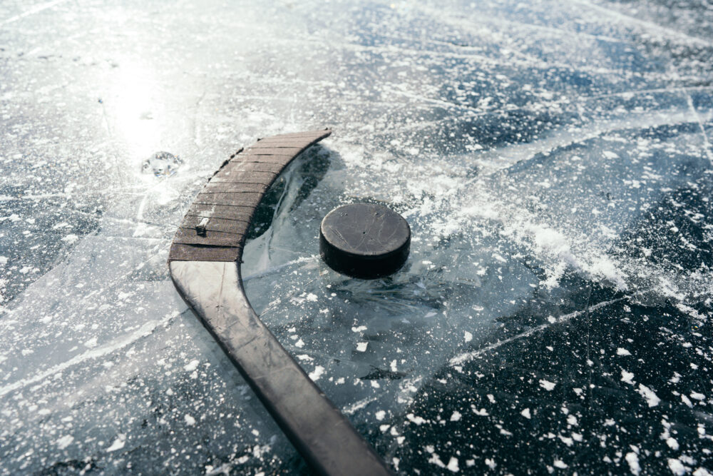 A hockey stick and puck on ice