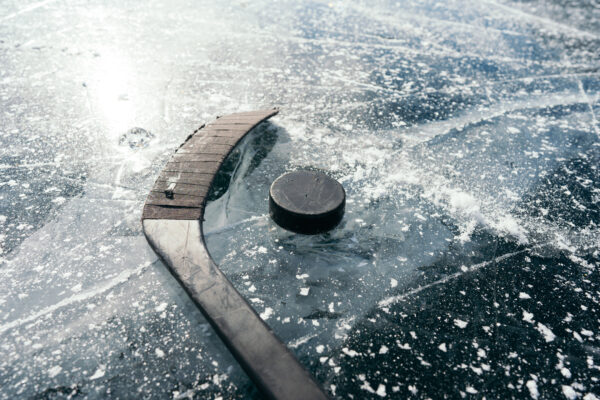 A hockey stick and puck on ice