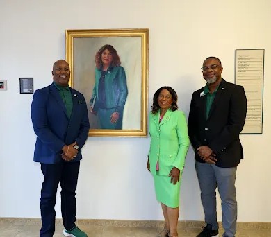 Kevin Bailey, Joyce Waddell '73 and Chris Smith with Waddell's portrait