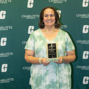 Shannon Homesley holds her alumni award