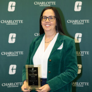 Tonya Bates holding her alumni award