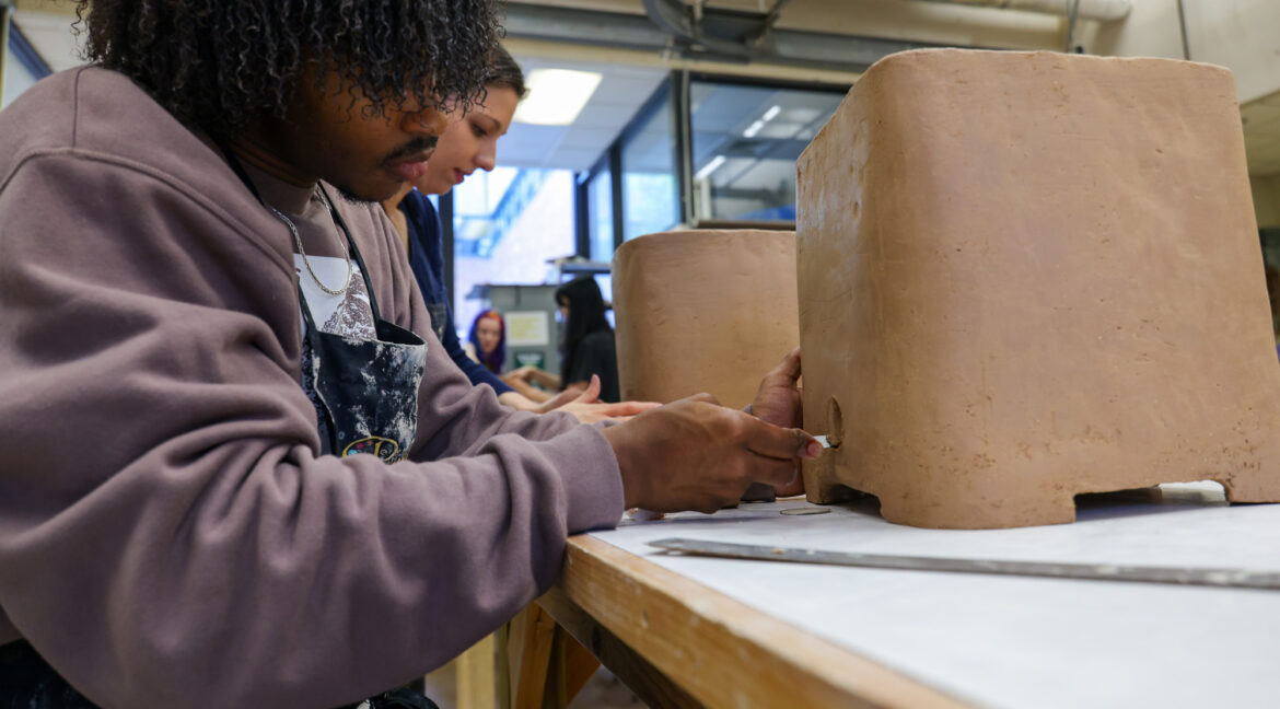 Group of people working with ceramics