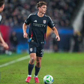 Ian Pilcher, San Diego FC A soccer player in a navy blue jersey runs with the ball on a field during a game.