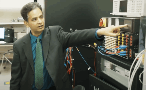 Sukumar Kamalasadan points at screen inside his lab