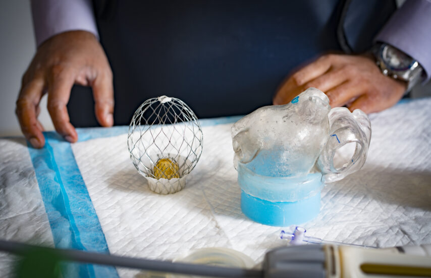 Hands placing lab equipment onto an absorbent pad.