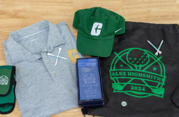 One Chaptr Creative Custom Charlotte hat, shirt and koozies on a display table