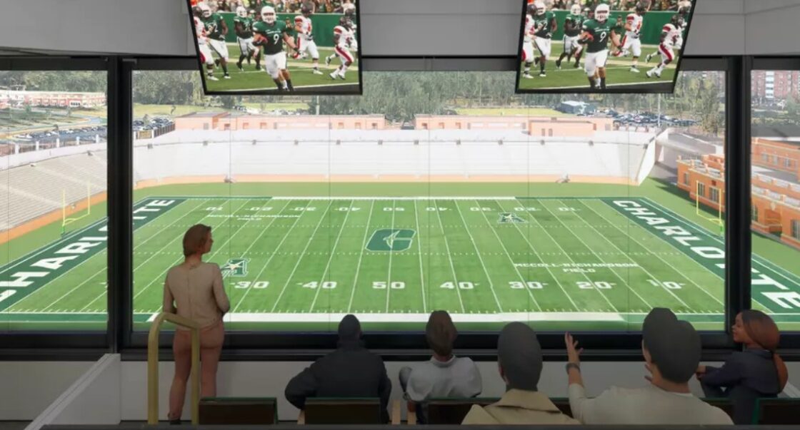 Rendering of a premium suite at Jerry Richardson Stadium, featuring indoor seating, televisions, and expansive windows overlooking the football field.