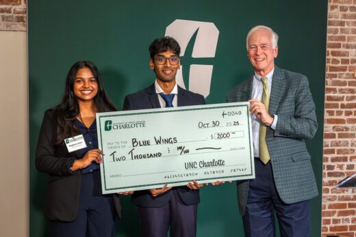 Siddarth Gaddam and Meghan Asaati receiving checks