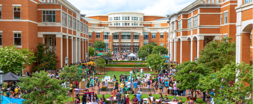 View of the CHHS/COED Plaza looking at the Student Union during the Student Org Showcase. There are students filling up every available walkway. 