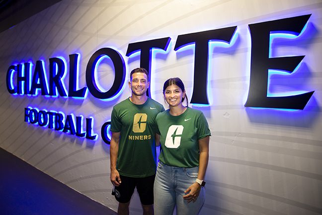 Bronicos in front of the Charlotte FC sign