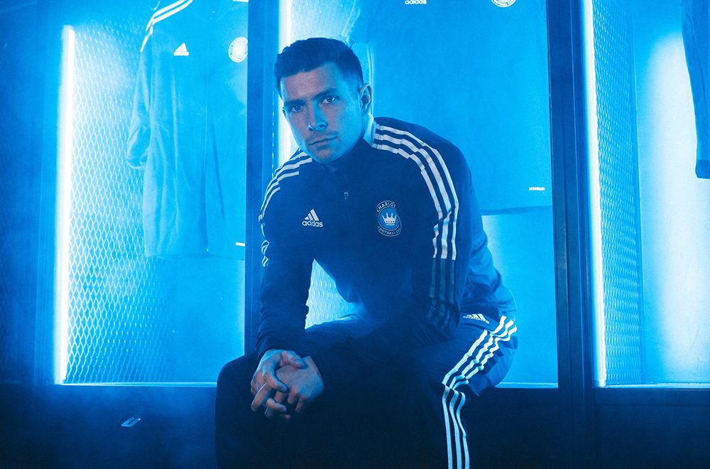 Bronico posing in the locker room for Charlotte FC marketing photos