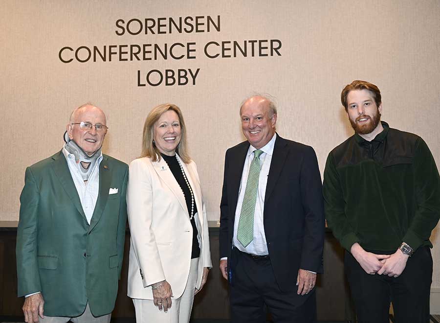 Photo: Niles Sorensen celebrates the naming of the hotel and conference center lobby in his honor with his son John, right, Chancellor Sharon L. Gaber and Gene Johnson ’73.