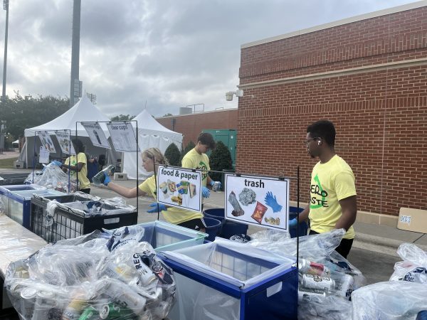 Students sort recyclables and trash as part of the Zero Waste Stadium inititaive