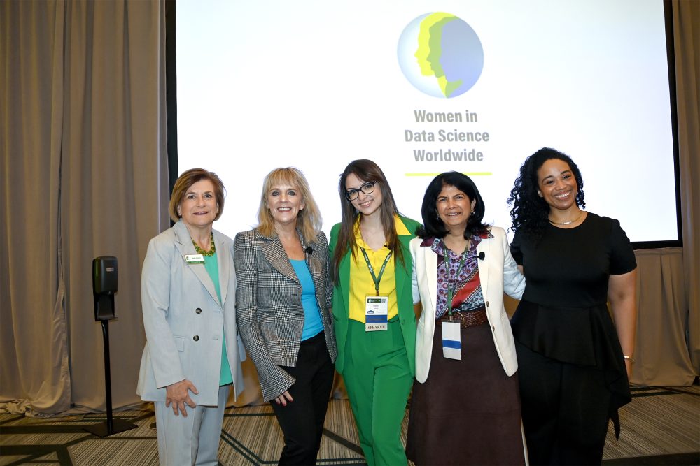 Five women stand together at a Women in Data Science Worldwide event.