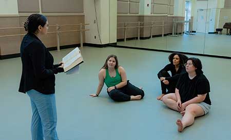 Photo, by Landry Hutchens, Chloe Gosline leads a book discussion with dance education students Maddie Worsley, Alexis Holloway, and Abbi Gray.