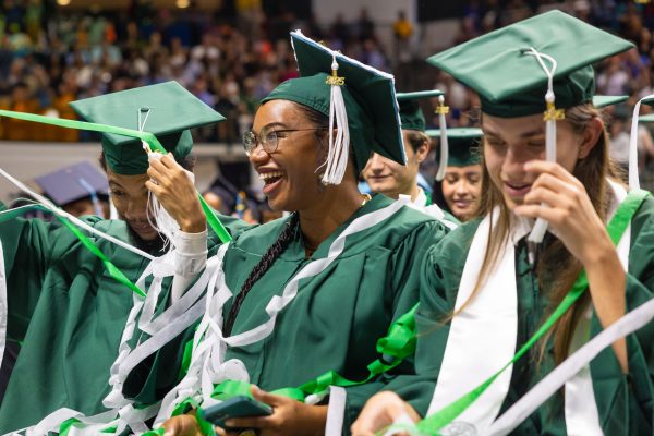 Smiling graduates with confetti