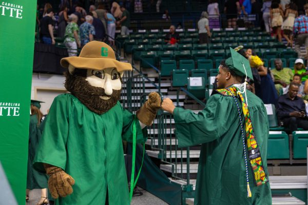 Norm fist bumps a graduate