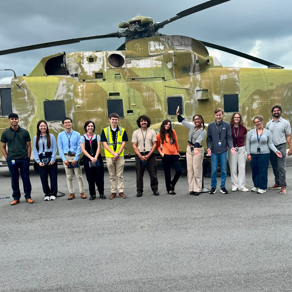 Myla Marve and interns posing by a helicopter