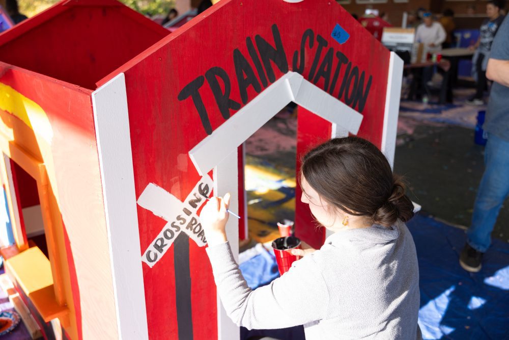 Levine Scholar paints train-themed playhouse