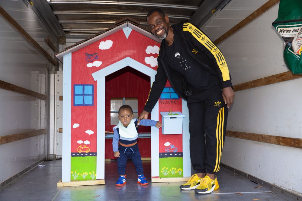 Family smiles by new playhouse