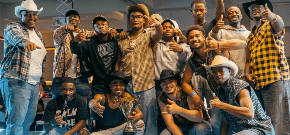 Alpha Phi Alpha Mu Tau fraternity pose with eighth stroll competition trophy